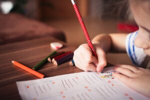 child drawing with a pencil 