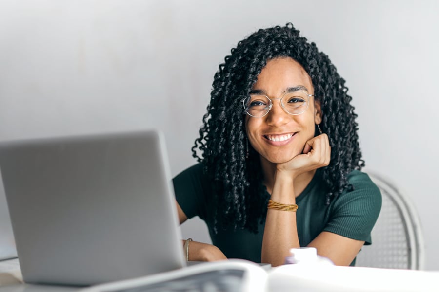 Woman with laptop running Student Progress Tracking Software