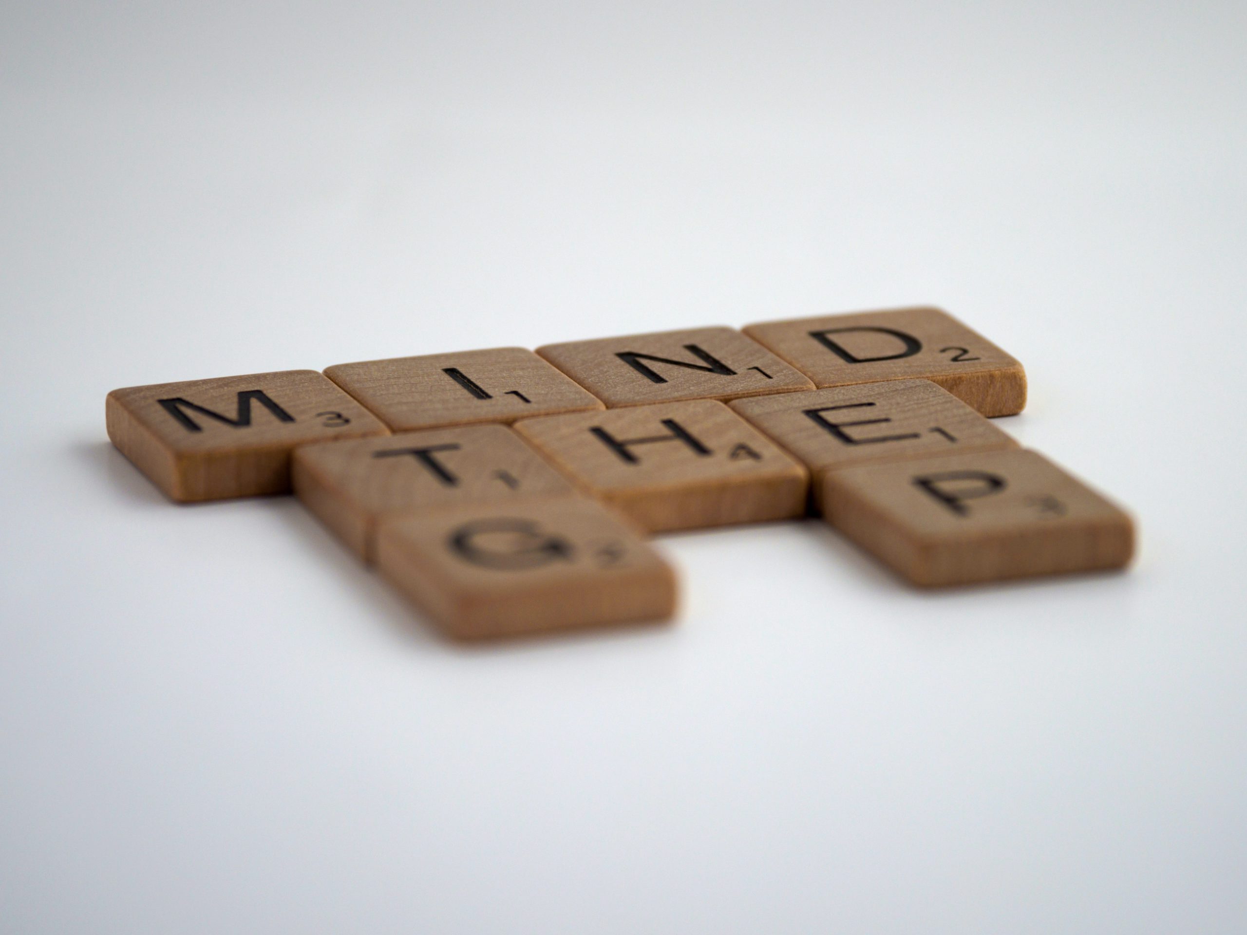 Wooden tiles spelling Mind the Gap